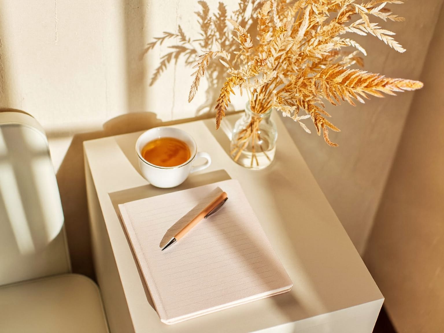 Herbal tea, notebook and dried flowers in a calm consultation room